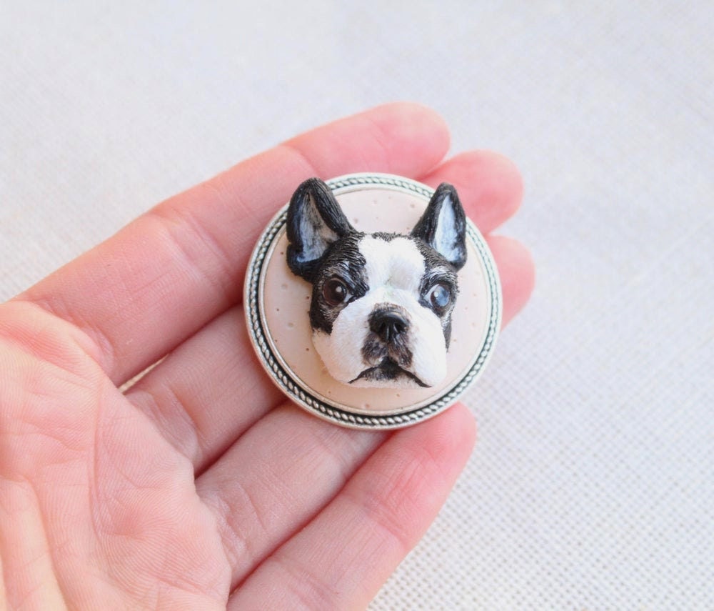 A hand-sculpted clay brooch customized to look like a dog's face, from Nico Made Me