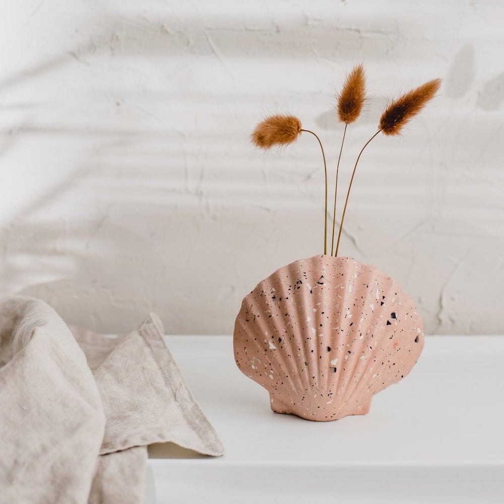 A pink terrazzo vase from Badger & Birch, shaped like a seashell