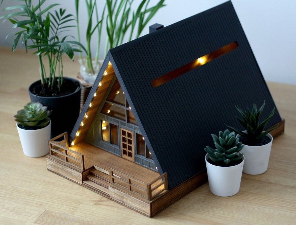 A wooden cabin-shaped wedding card box from Baraboshkin House