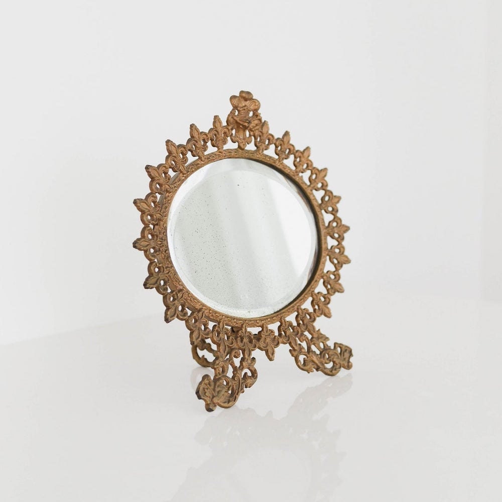 A vintage fleur de lis vanity mirror from Otherwise Shoppe