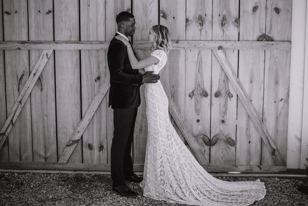 A black and white portrait of Emily and Terrell on their wedding day