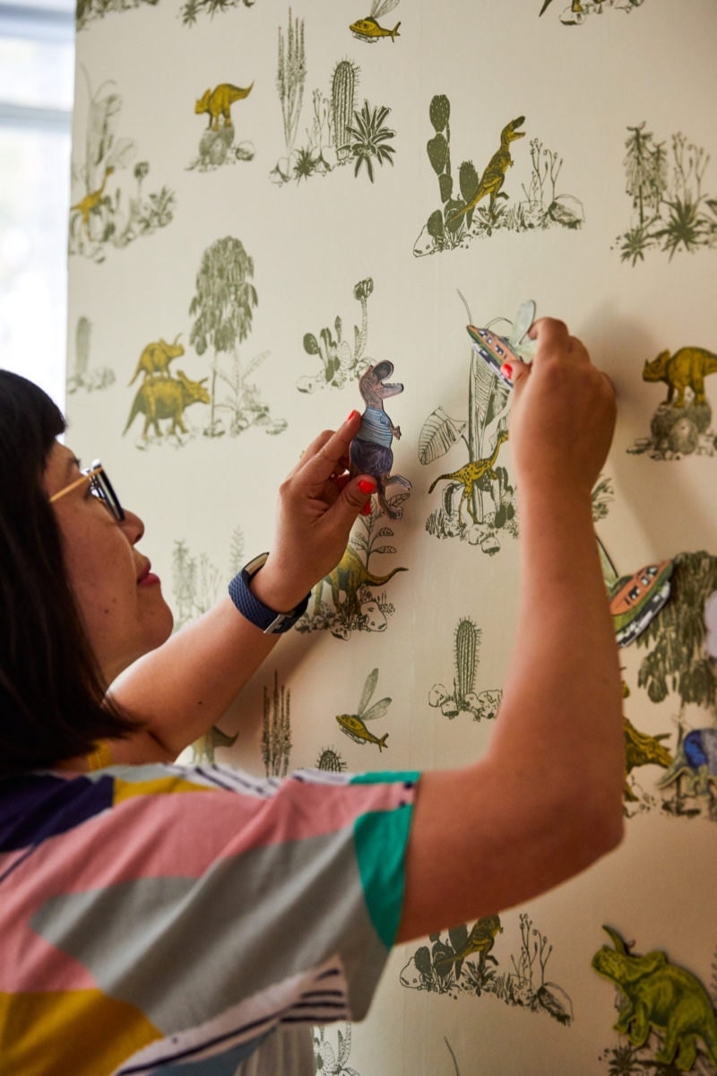 Sian demonstrates how to use the magnetic characters that go with her dinosaur wallpaper design.