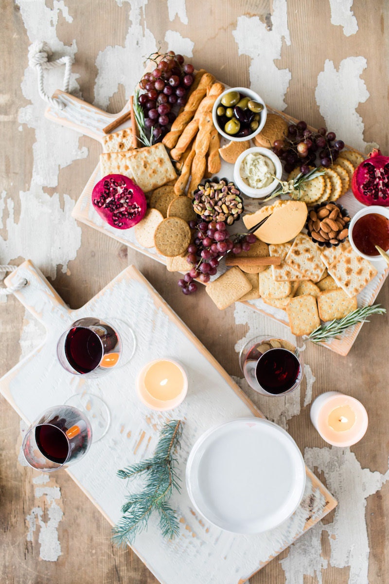 Festive holiday charcuterie spread on a rustic white cutting board