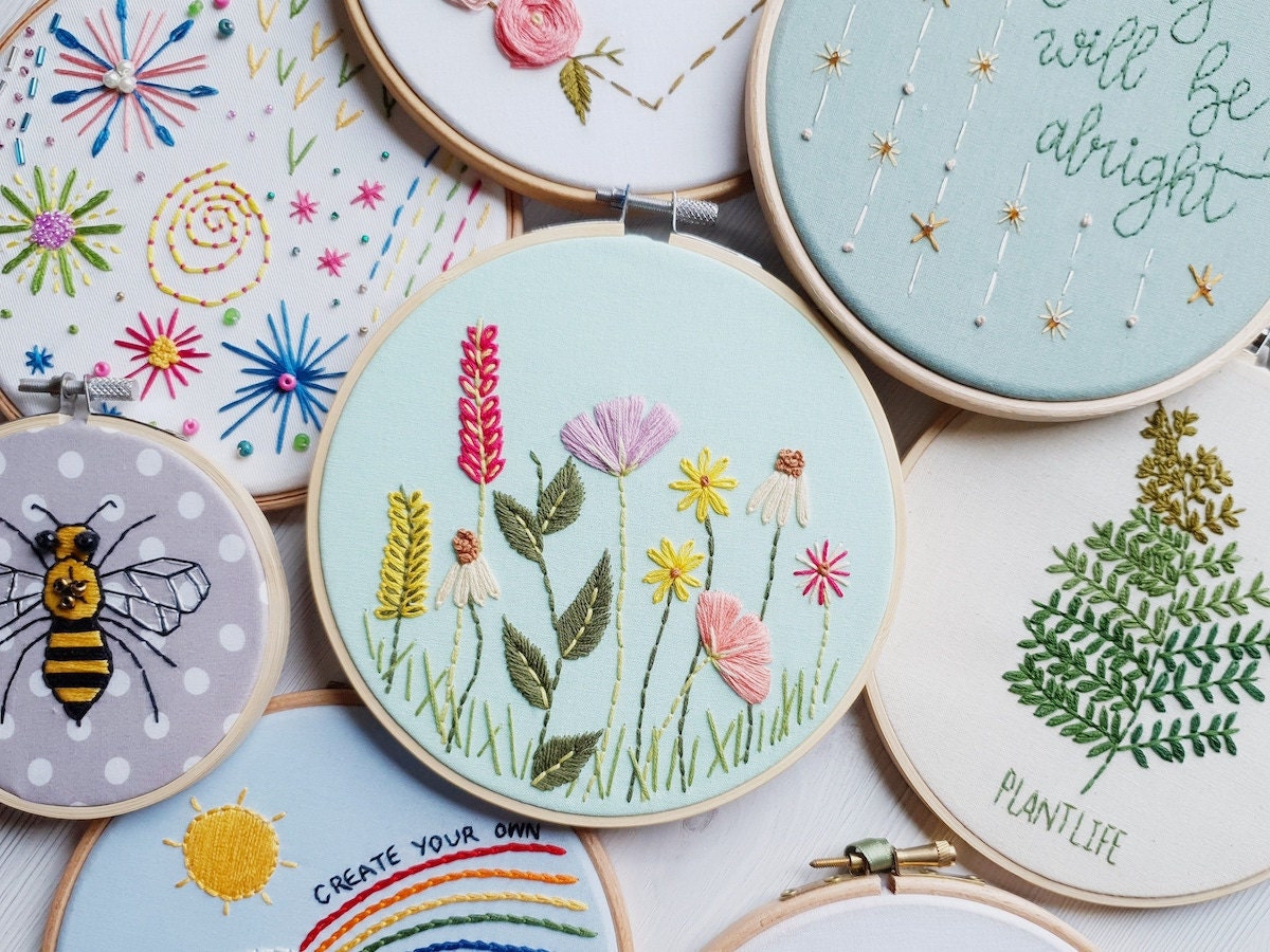 A pile of completed embroidery hoop art from Natalie Gaynor Designs