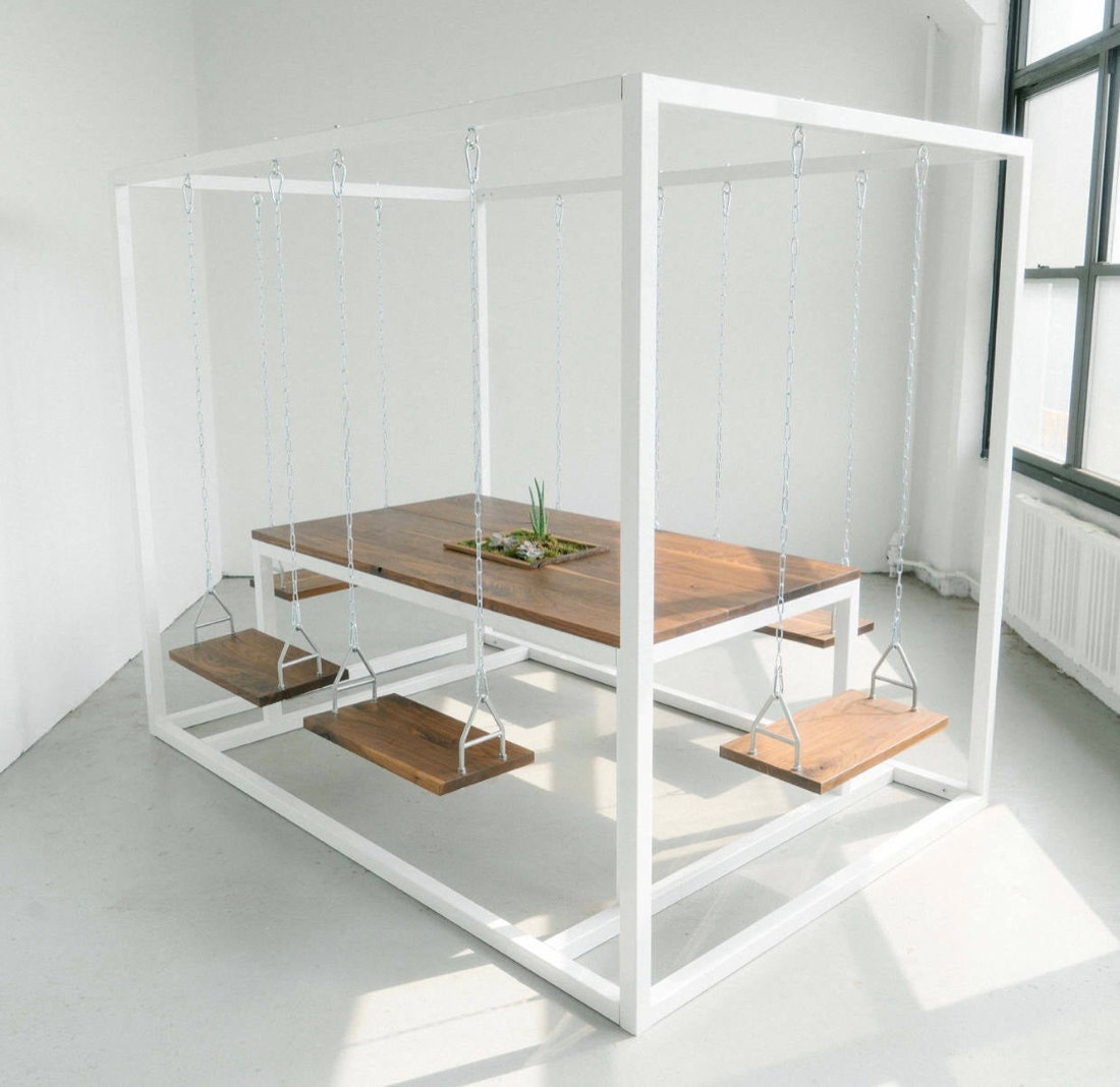 A dining table with swinging seats from Swing Tables
