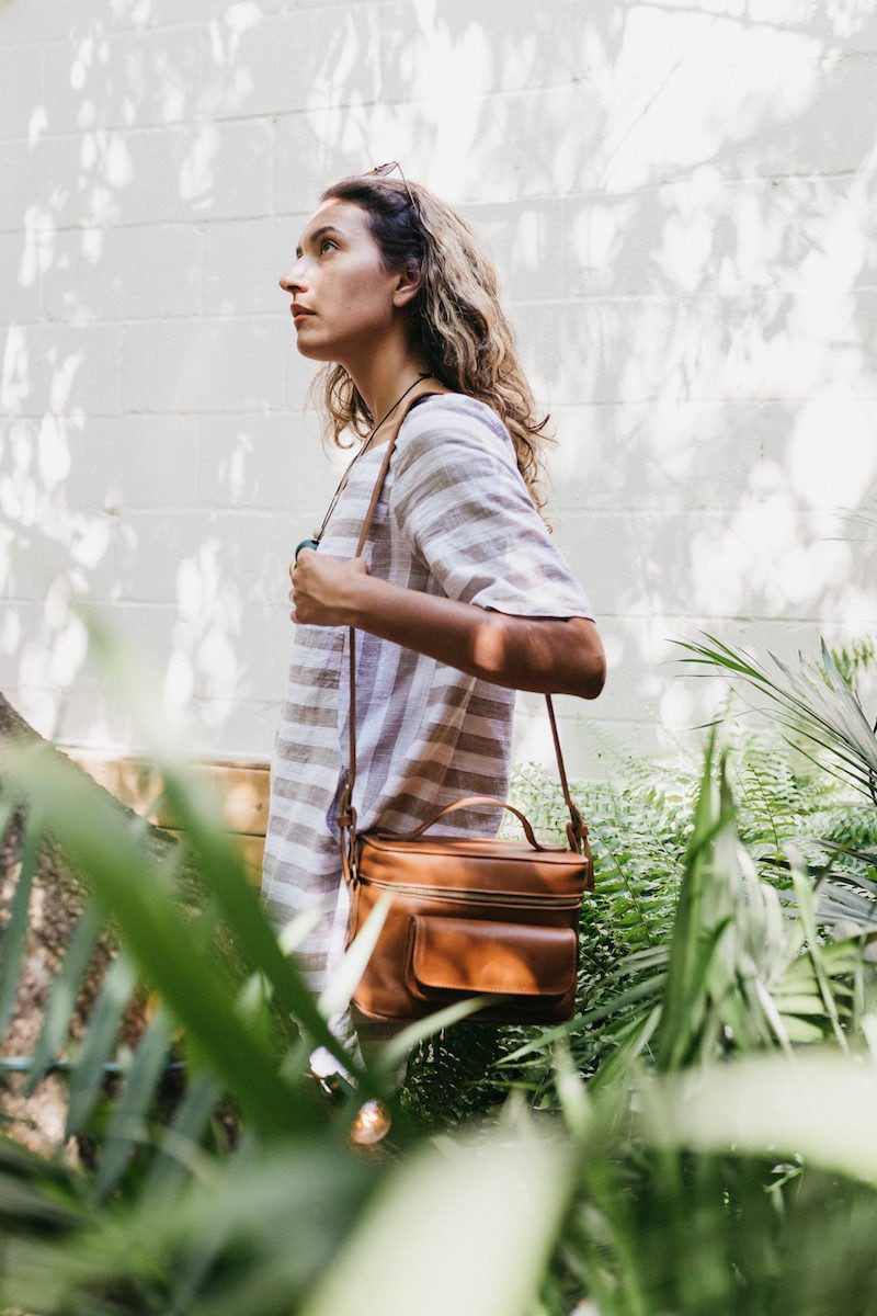 Jacqueline walking with one of her leather camera bags