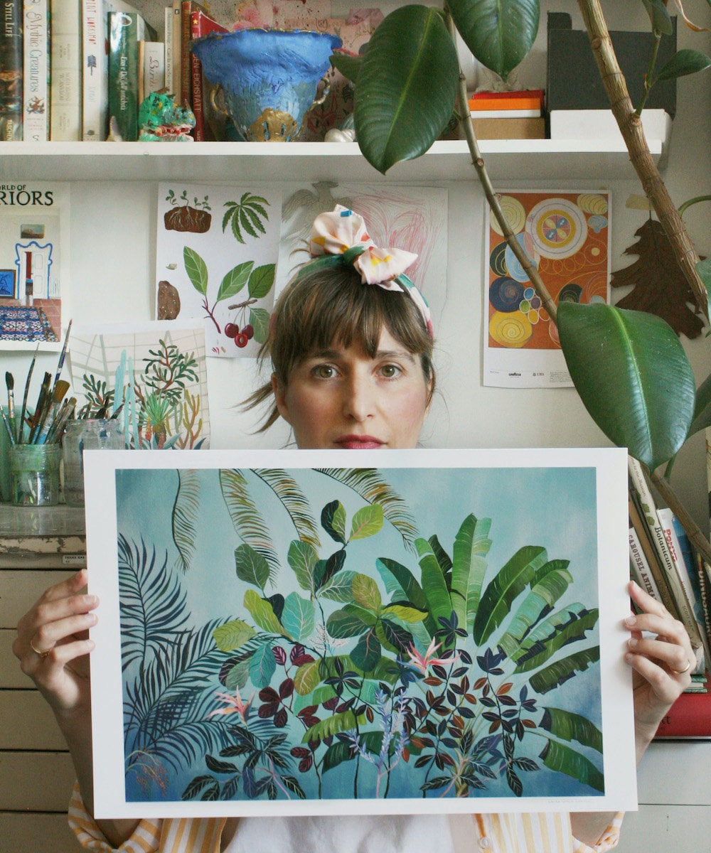 Painter Laura Garcia Serventi posing with her "Birds of Paradise" botanical art print.