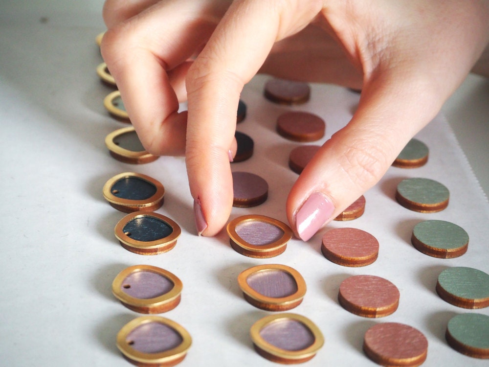 Assembling layered round earrings.