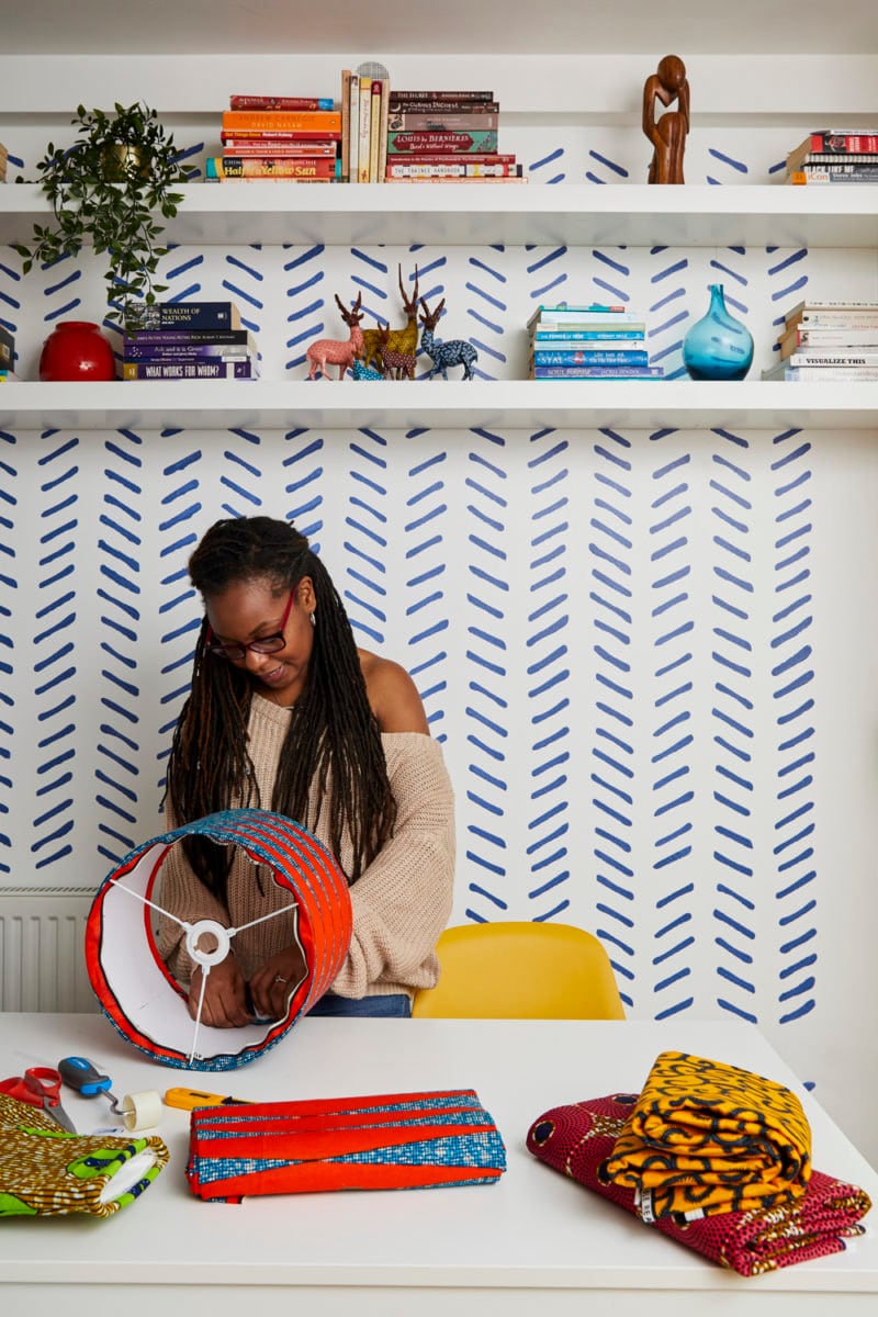 Natalie affixes colorful fabric to a drum-shaped lampshade frame