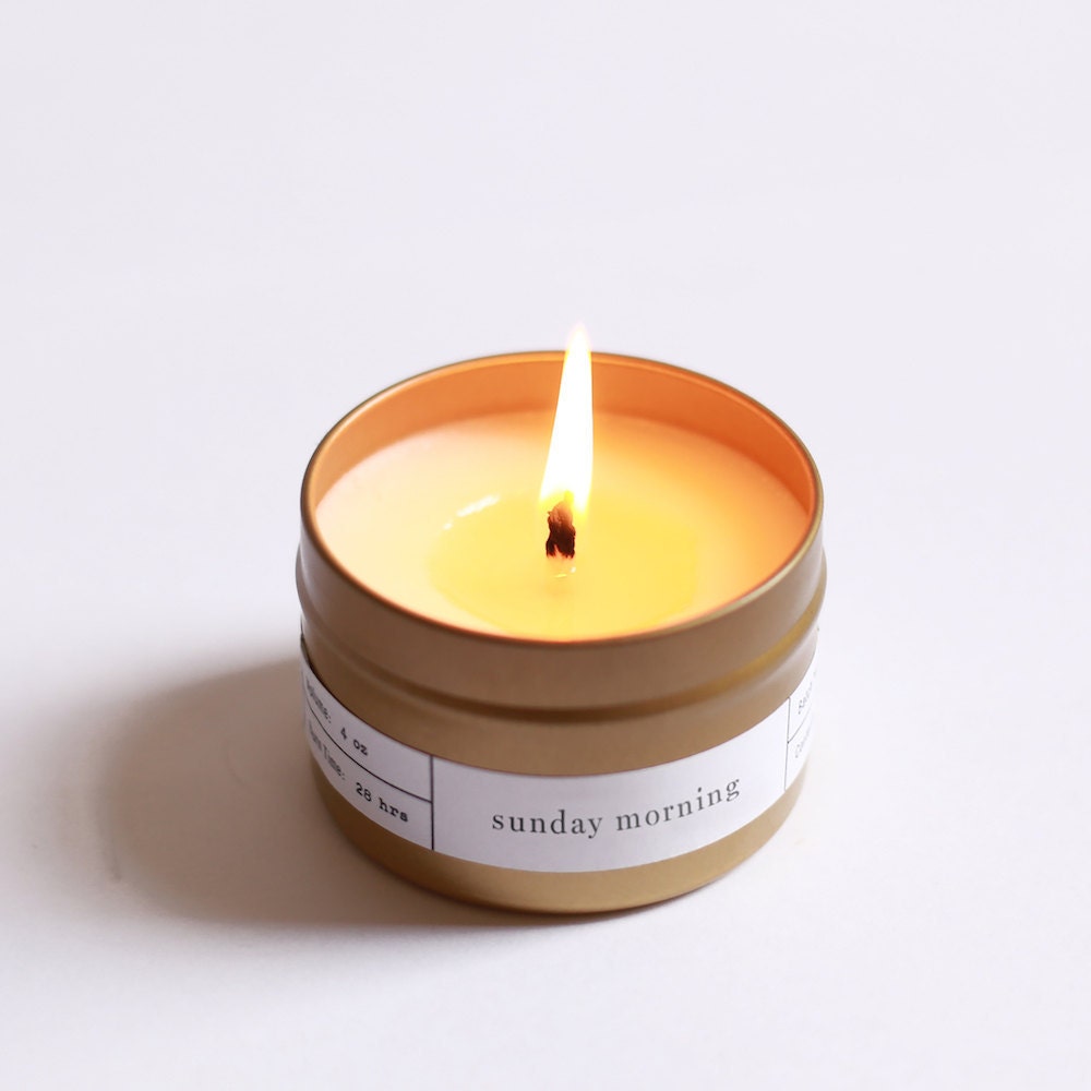 A soy wax travel candle in a brushed gold tin from Brooklyn Candle Studio.
