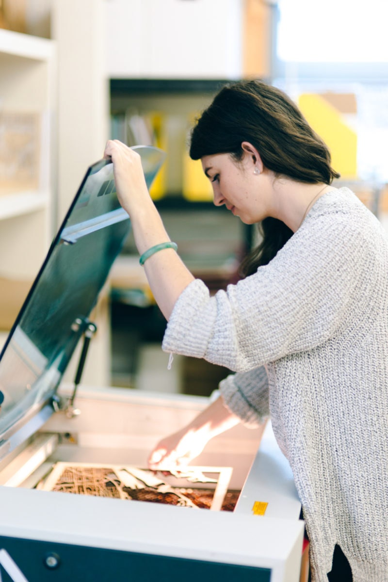 Ali uses her laser cutter in her studio.