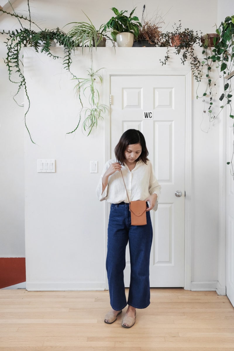 Quynh models a handmade leather phone sling
