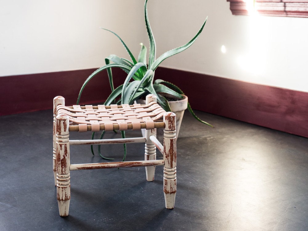 Styled shot of finished upcycled stool with succulent in background