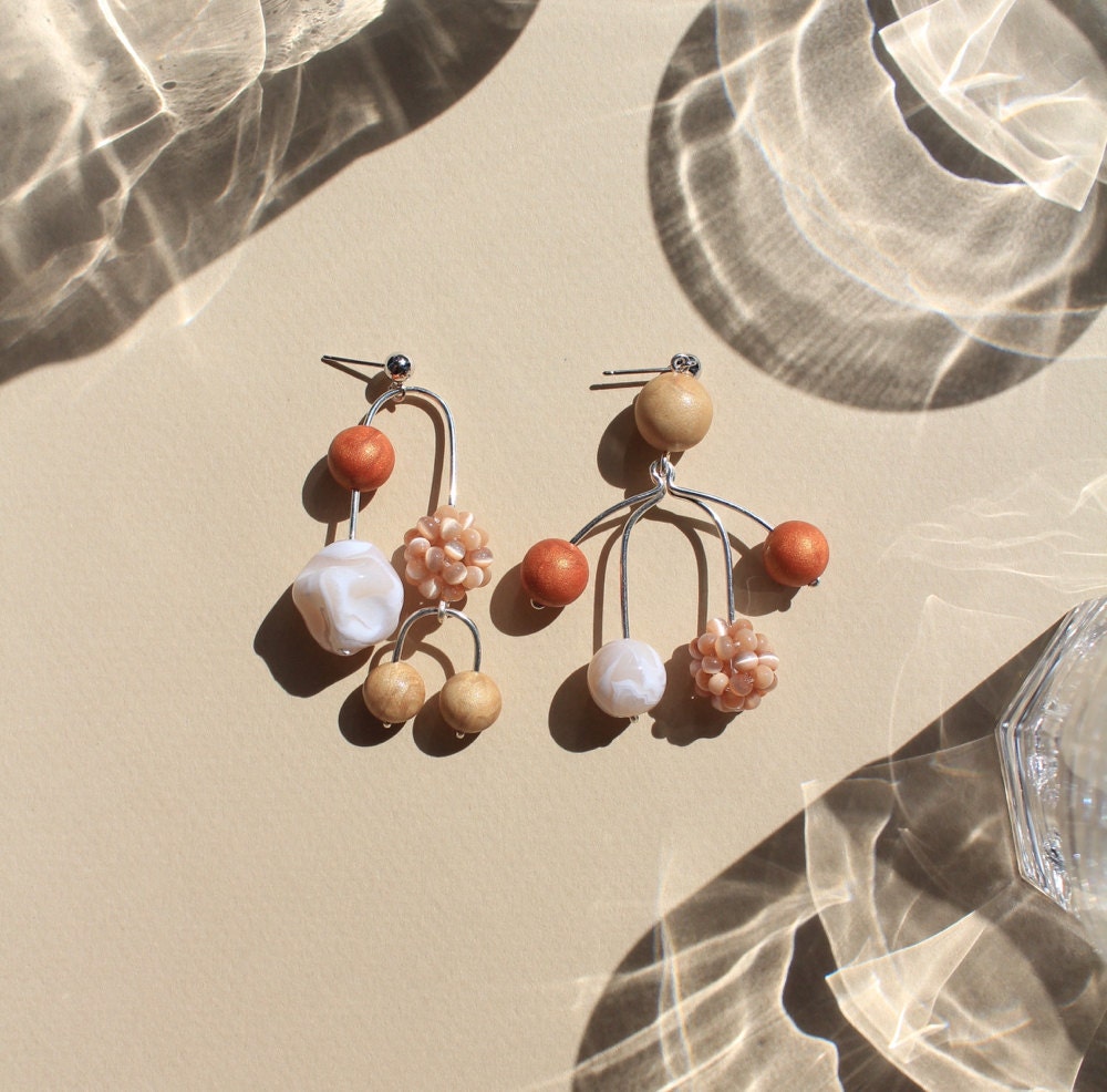 Asymmetrical mobile statement earrings from TSUNJA