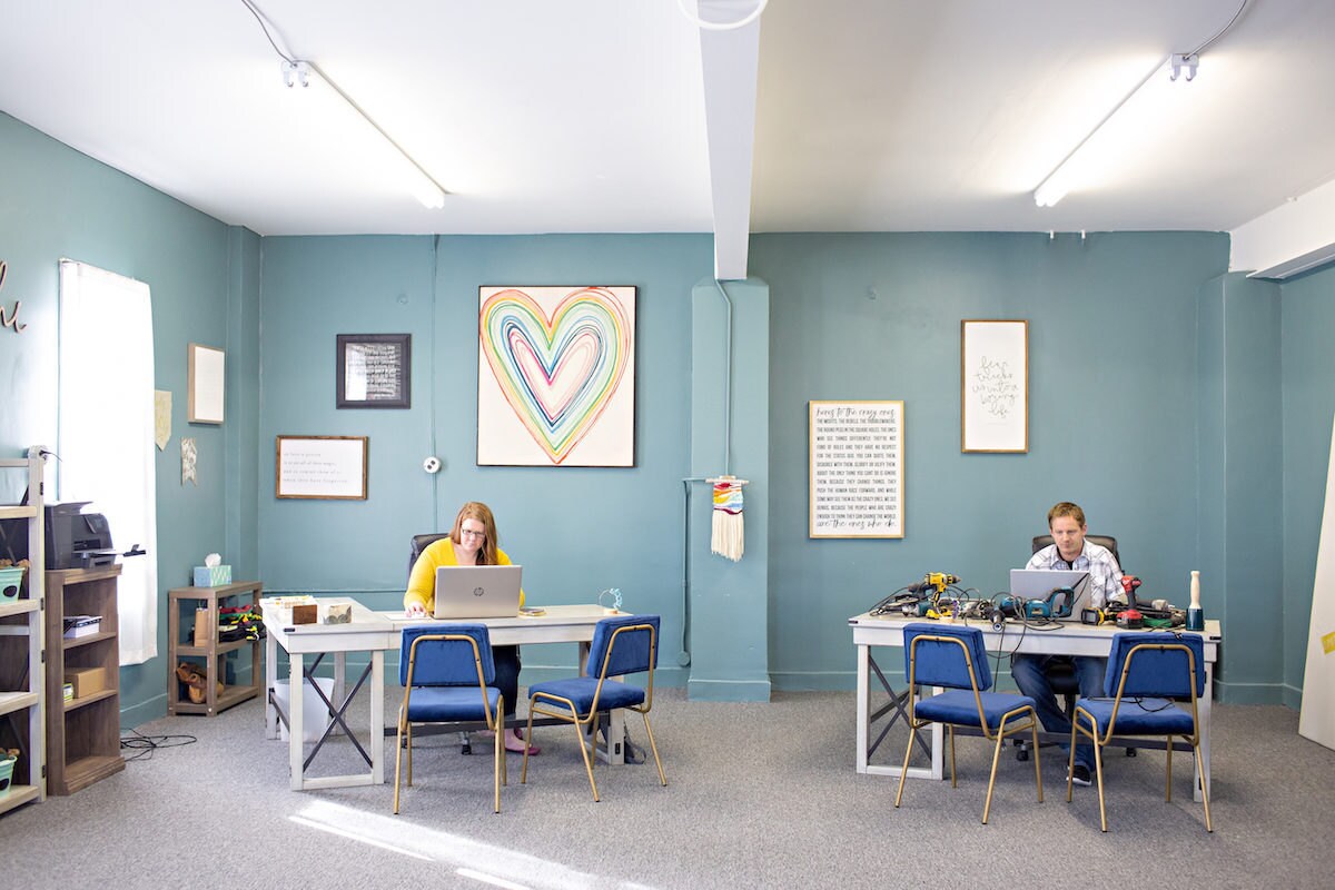 Stacey and Jesse Bannor in their office working at their desks