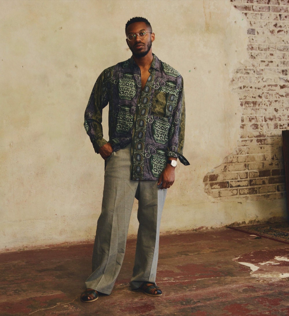 Norman models an abstract printed oxford and gray slacks.