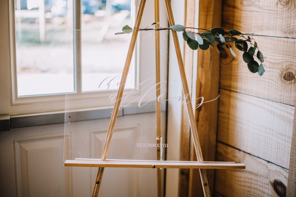 An acrylic name sign that Emily designed for her wedding day reads "The Allens"