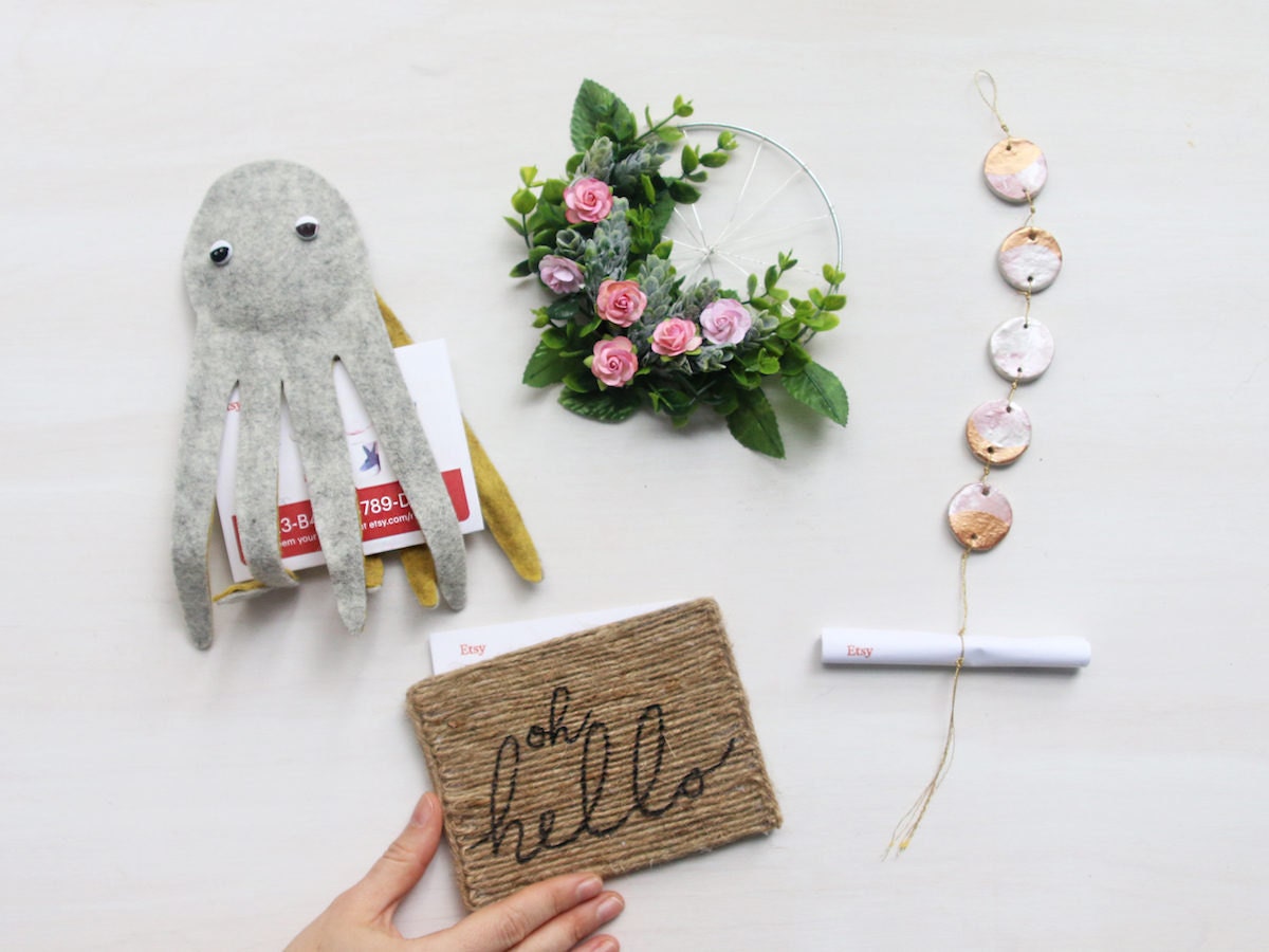 Four playful DIY gift card carriers in the shape of an octopus, wreath, doormat, and moon phase ornament