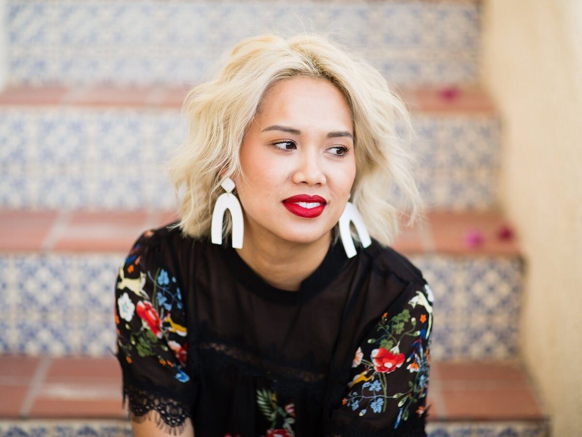 Model wearing white polymer clay statement earrings from Sigfús Designs