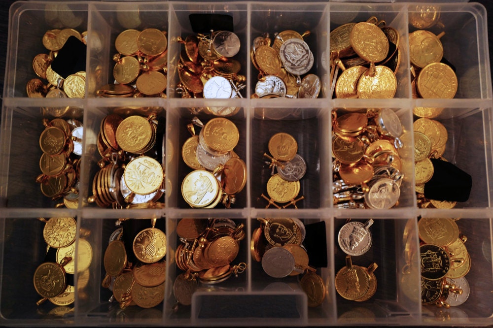 An organizer filled with coin pendants from different countries