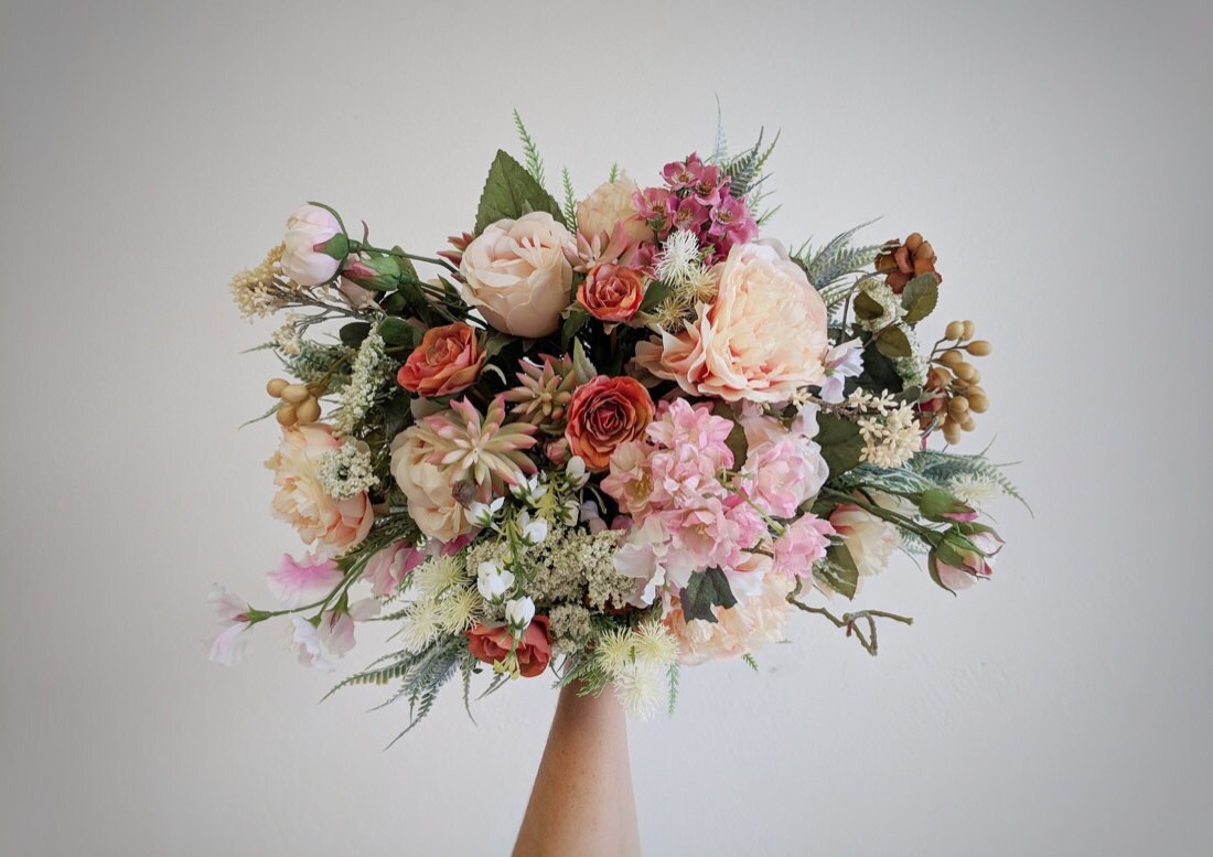 An example of a peachy pink bouquet with succulents from The Faux Bouquets