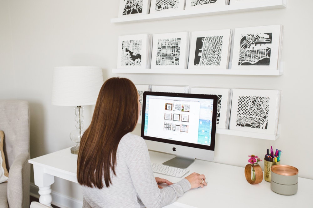 Karen working on her Etsy shop on her computer in her studio