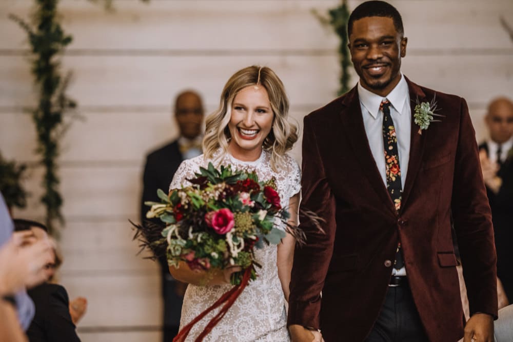 Emily and Terrell recess down the aisle after their I dos, all smiles