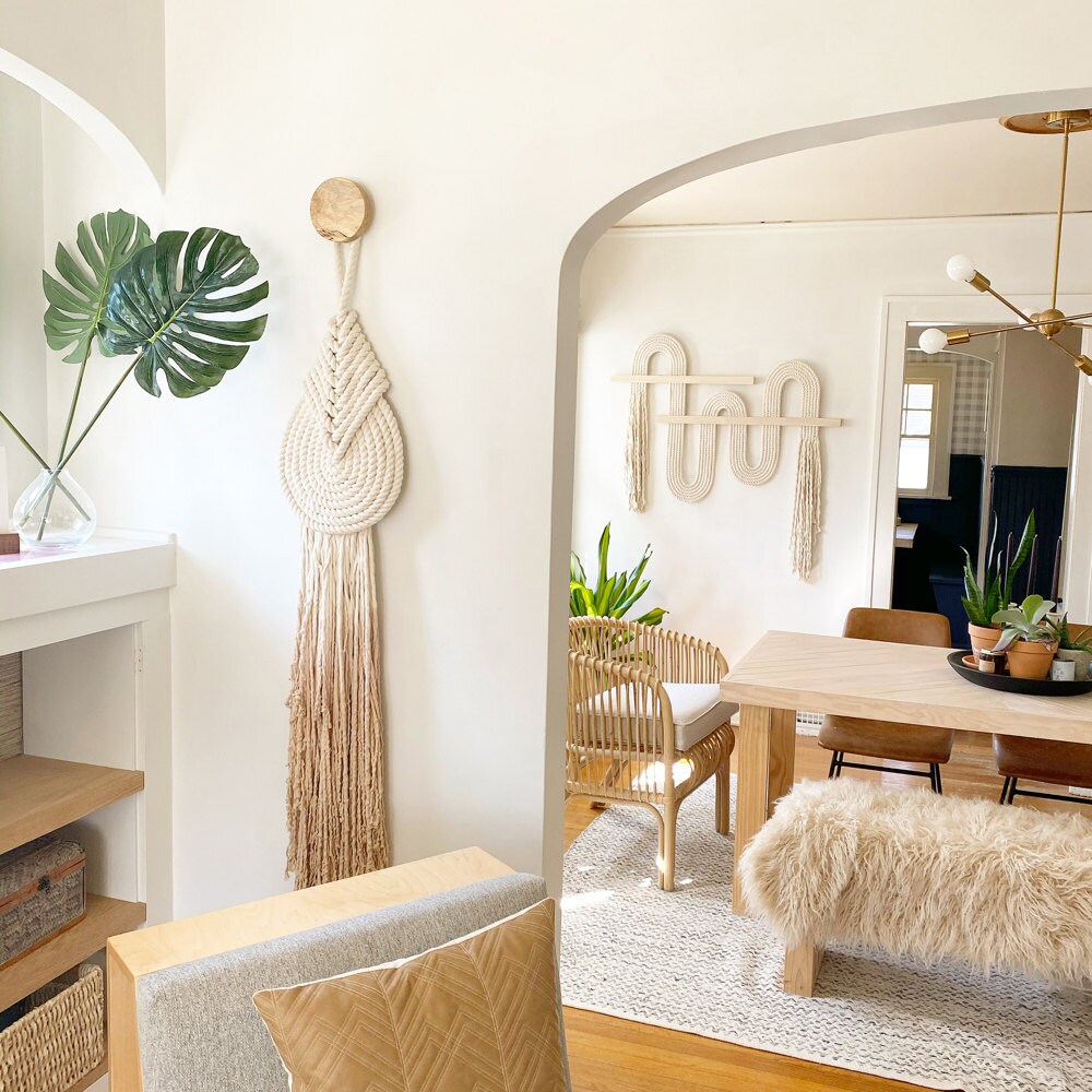 A medium "Lyric" macrame wall-hanging with accent knob in the foreground of Candice's showroom, and an extra-large "Vibrato" macrame wall-hanging in the background.