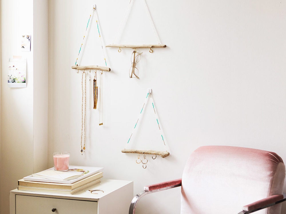 Driftwood jewelry organizers hanging on a wall