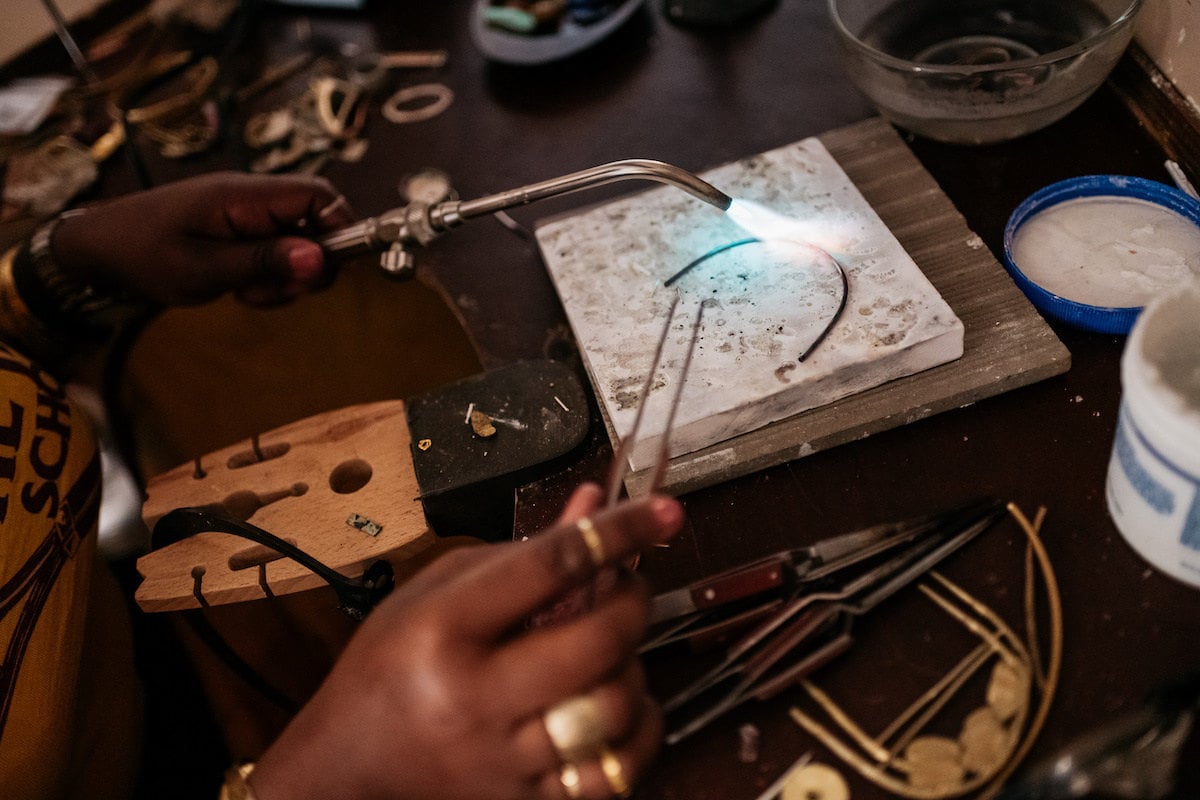 Alicia works on blow-torching one of her pieces in her studio.