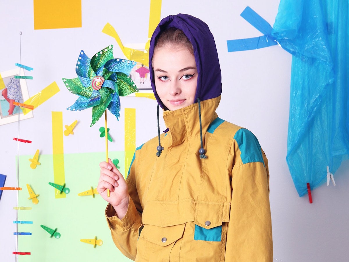 Woman modeling a mustard-colored 90s windbreaker from Old Wool