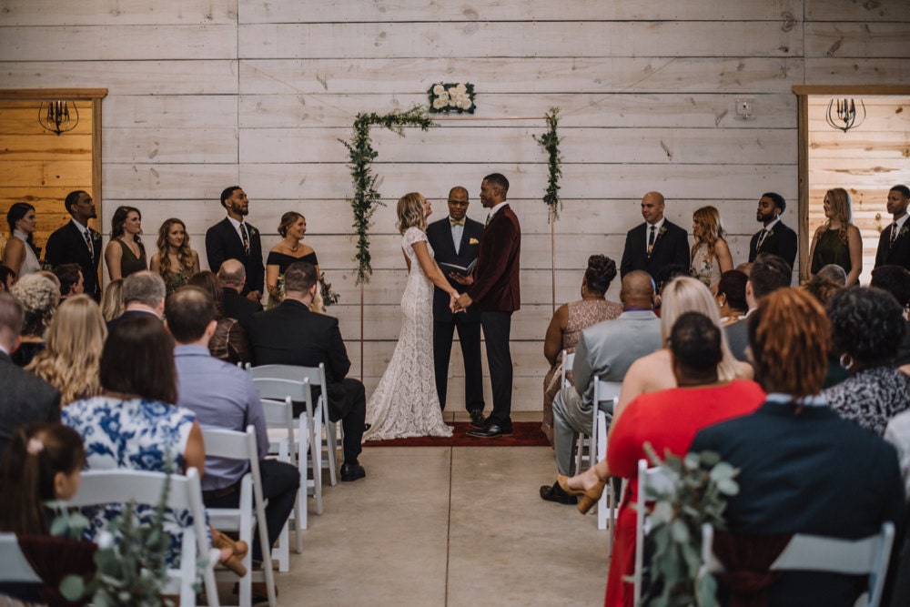 Emily and Terrell exchanging vows in front of their friends and family