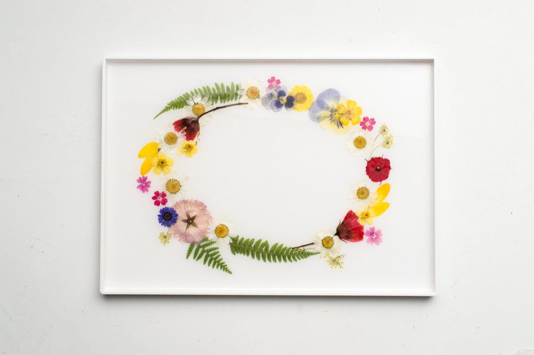 The completed pressed flower tray with an even coat of resin and neatly arranged florals