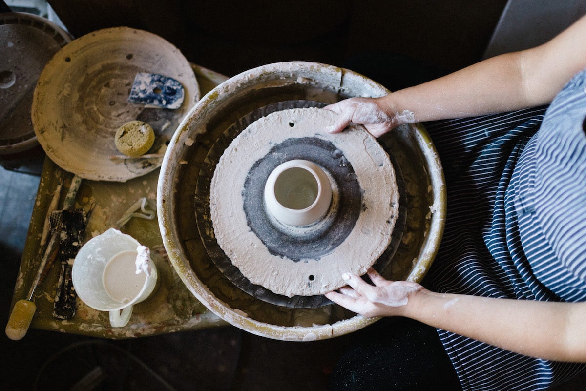 Yumiko throws a piece on her pottery wheel