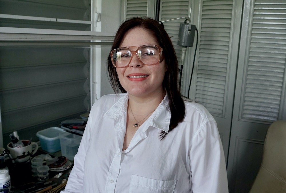 A portrait of jewelry designer and metalsmith Aleishla López in her Puerto Rico studio.