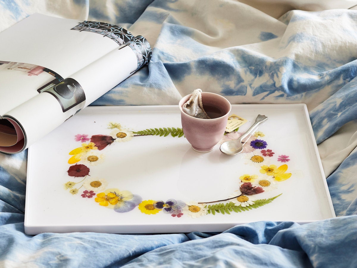 Styled photo of a completed DIY pressed flower tray being used to serve tea in bed