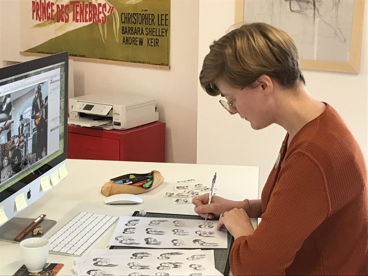 Lilimandrill shop owner Lise Grossmann sketching portraits in her studio.