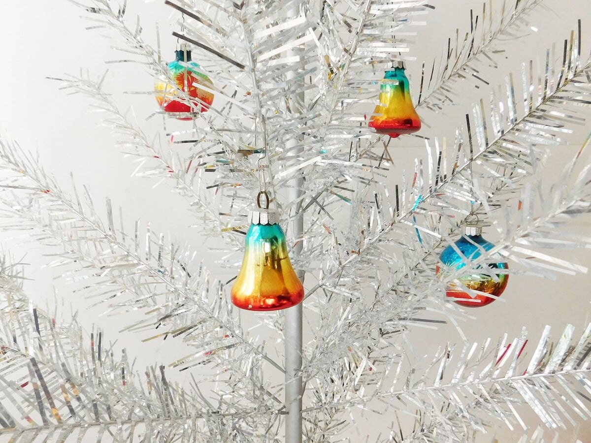 Vintage aluminum Christmas tree with silver tinsel design and ornaments vintage aluminum Christmas tree with ornaments