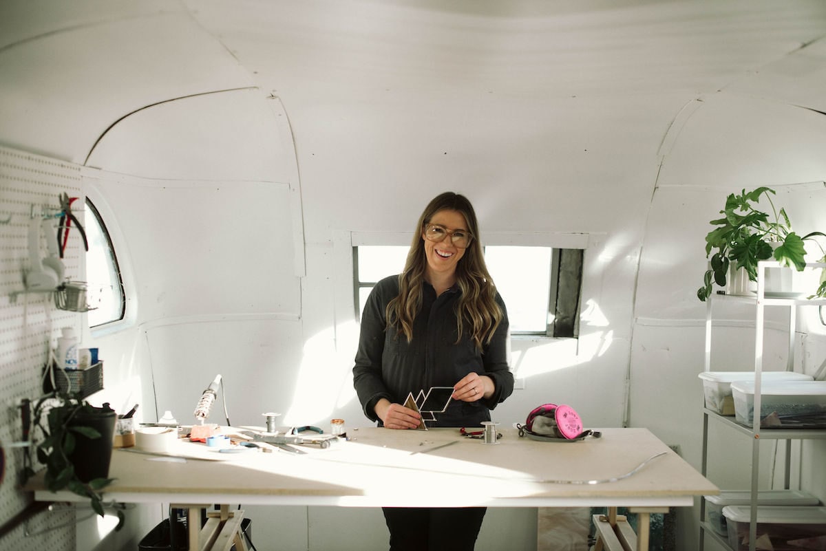 Lauren holding one of her finished pieces in her studio