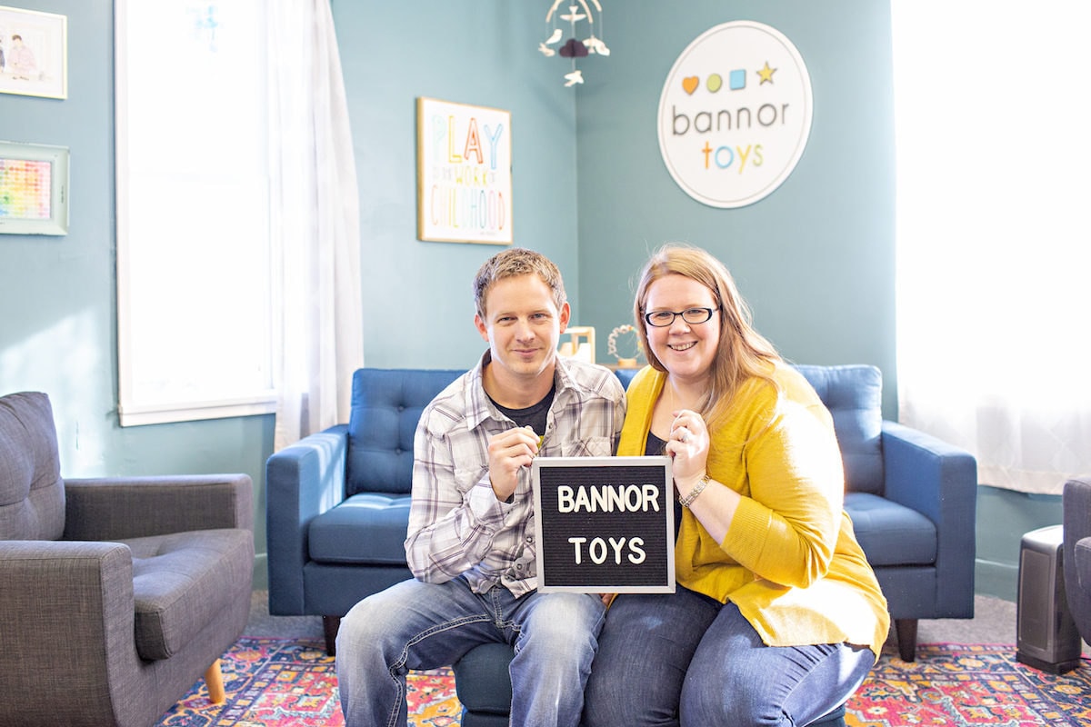 Seated portrait of Bannor Toys proprietors Stacey and Jesse Bannor in their Madrid, Iowa studio headquarters