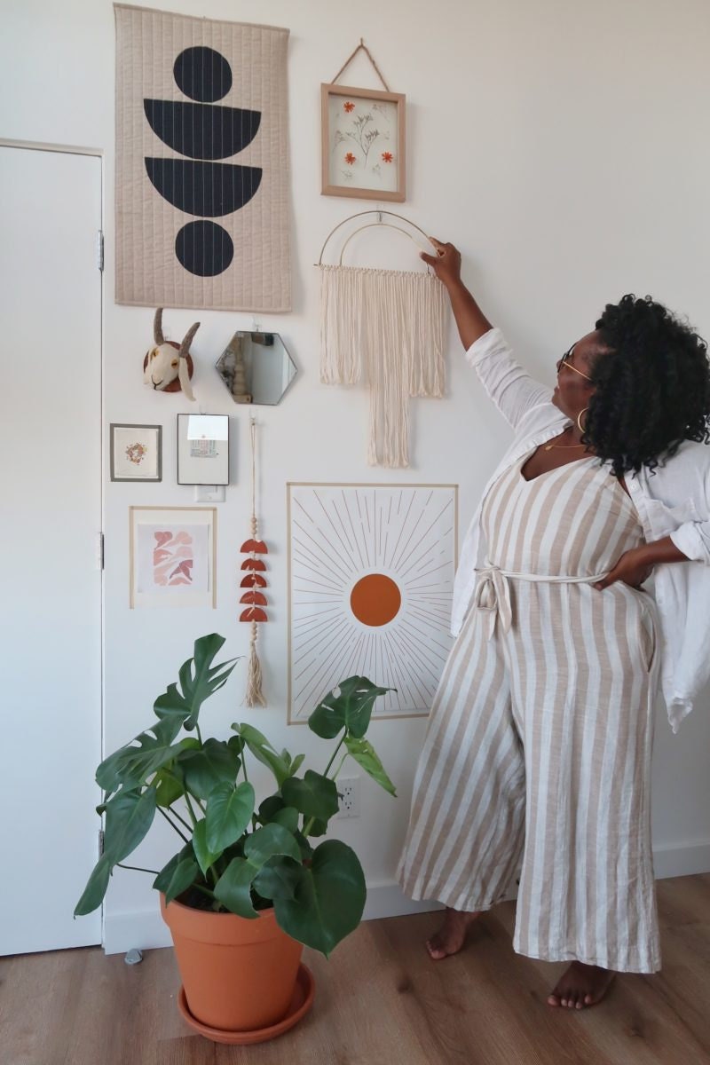 Janea hangs a sculptural fringed wall hanging