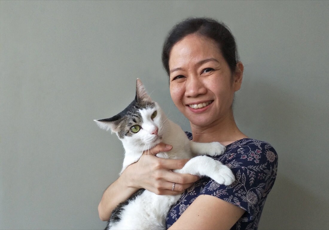 Orawee poses with her cat