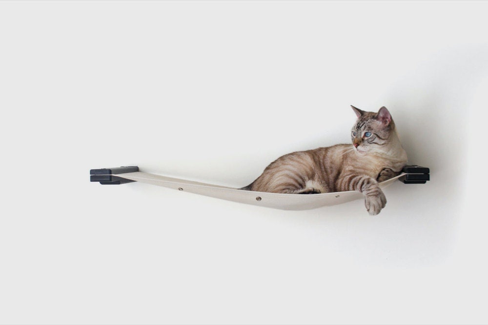 A wall-mounted canvas cat hammock from CatastrophiCreations