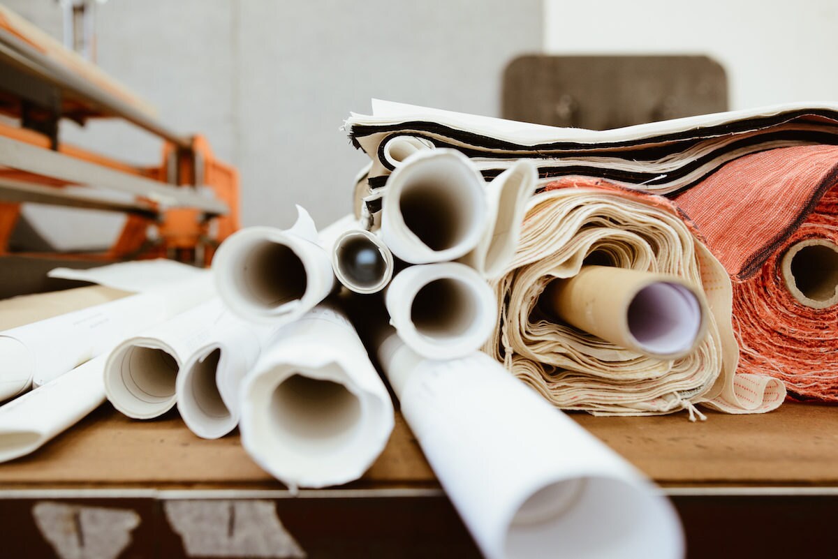 Pattern markers and fabric rolled up and awaiting use in Rabia's studio