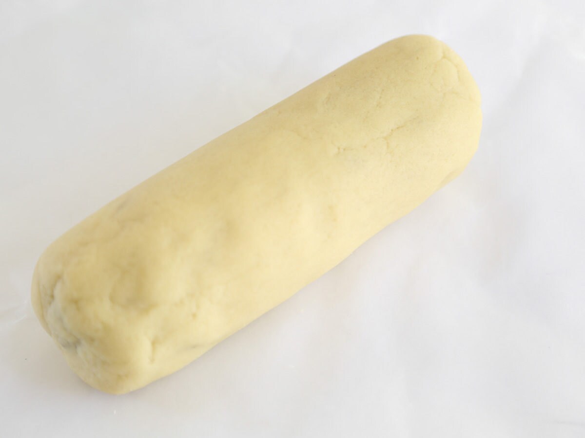 Form almond pine cone dough into a log Form almond pine cone paste into a log