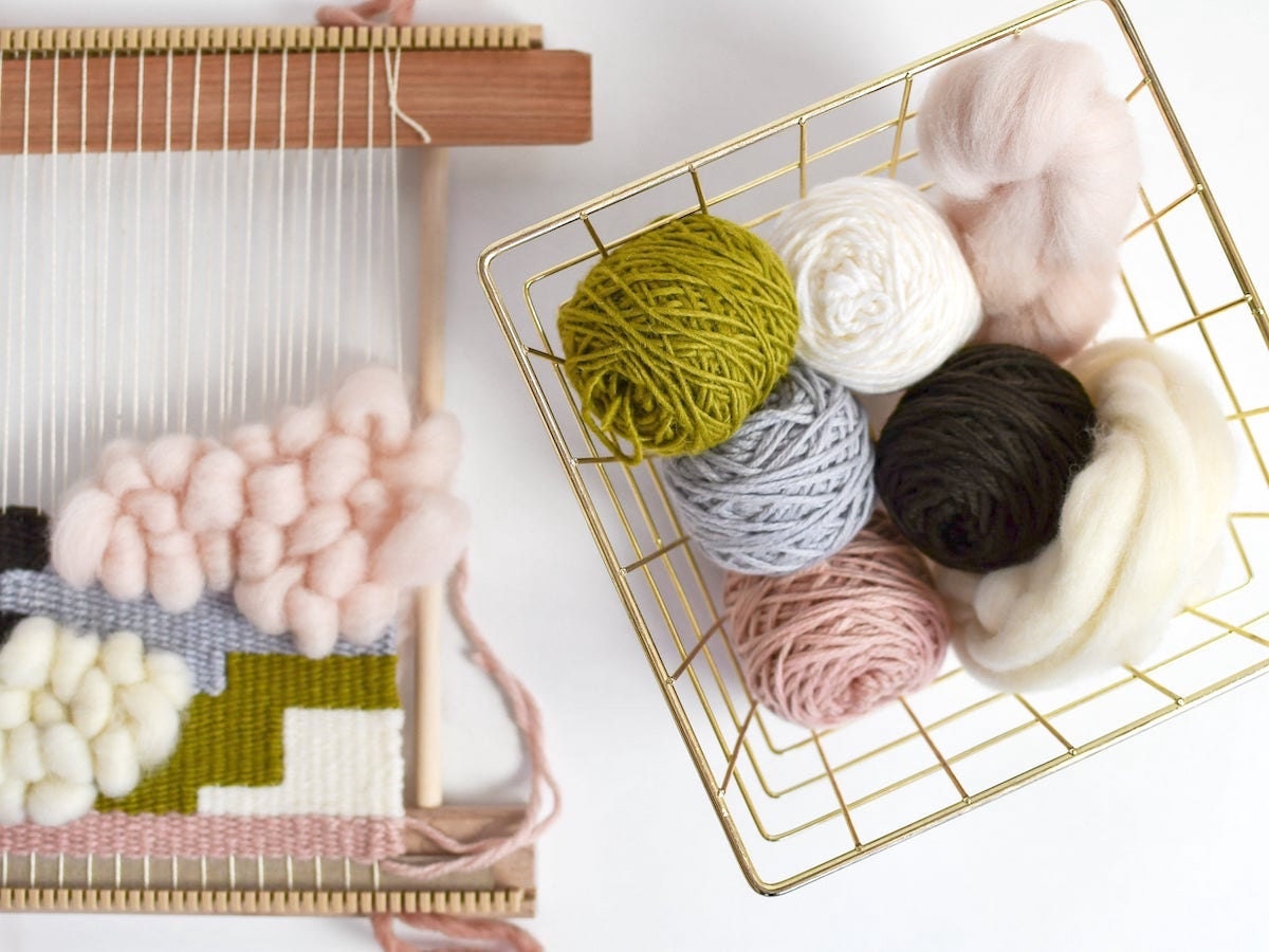 A WIP weaving loom and colorful yarns from Oake and Ashe
