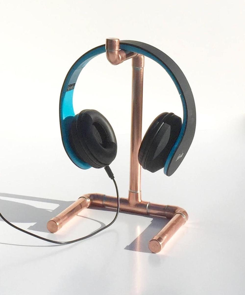 A set of headphones on display on a headphone stand.