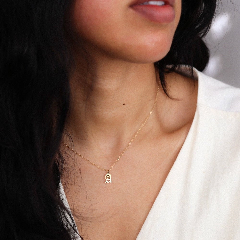 A dainty Old English initial pendant necklace from EVREN.