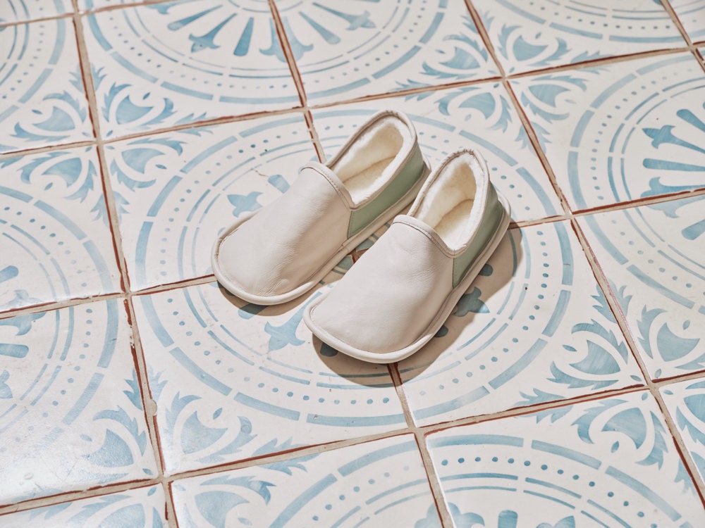 A pair of shearling-lined leather Moccasin slippers from the Tan France x Etsy collection