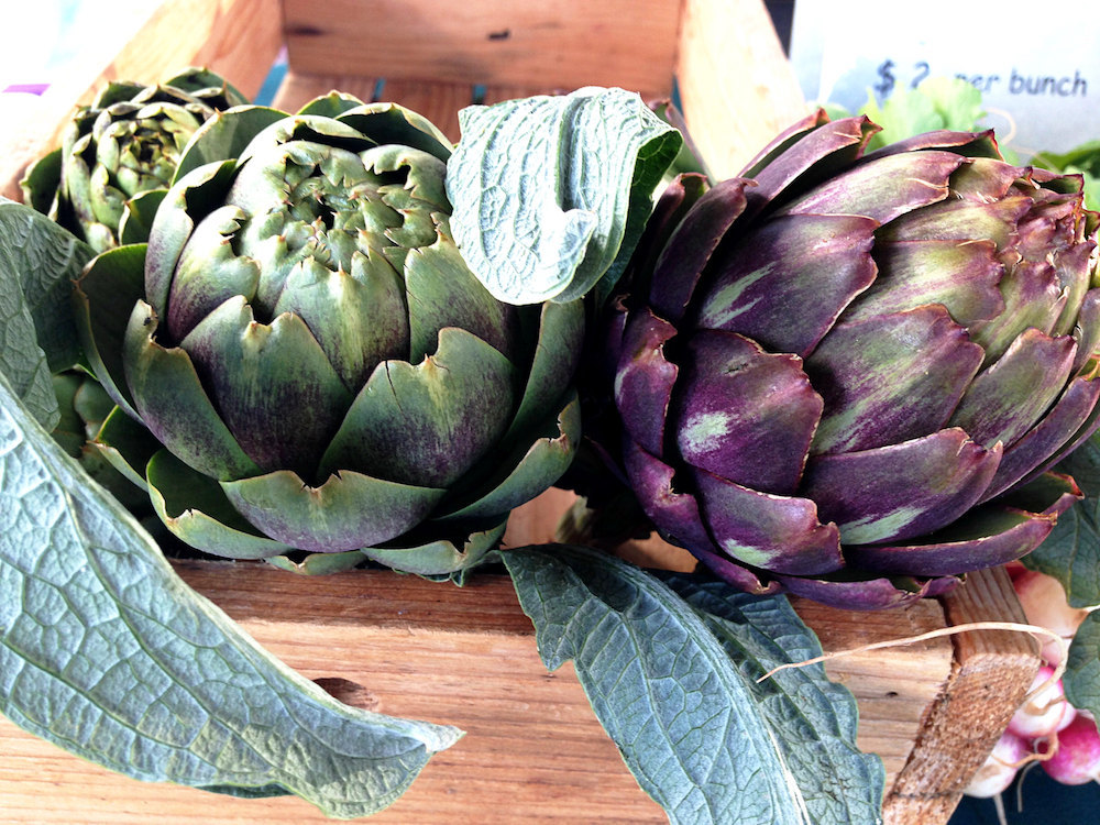 A wooden crate of artichokes